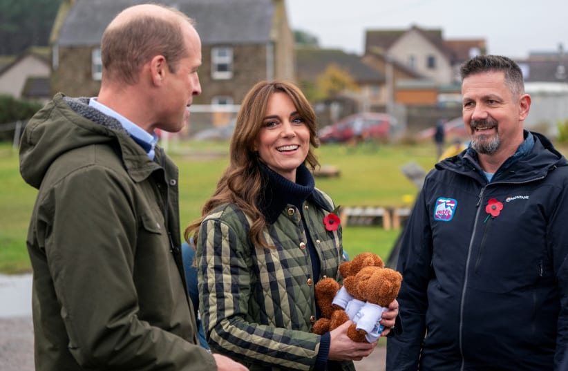  Britain's Prince William, and Kate, the Princess of Wales also known as the Duke and Duchess of Rothesay when in Scotland, are presented with 3 teddy bears for their children during their visit to Outfit Moray, in Moray, Scotland, Britain November 2, 2023. (photo credit: JANE BARLOW/POOL/REUTERS)