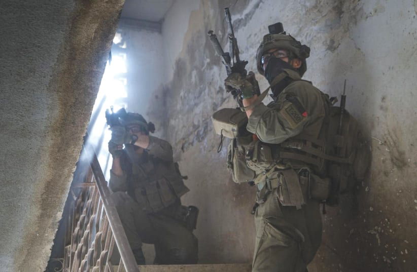  OLDIERS operate in the Gaza Strip this week. Israel may be isolated, but Israel will soldier on. It is the world that will suffer the greater loss, the writer asserts. (photo credit: IDF/Reuters)