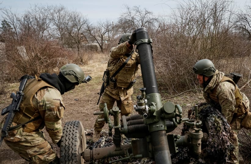  Service members with the Freedom of Russia Legion under the Ukrainian Army prepare to fire a mortar at a Russian military position, as Russia's invasion of Ukraine continues, in Donetsk region, Ukraine, March 21, 2023. (photo credit: REUTERS/Alex Babenko)