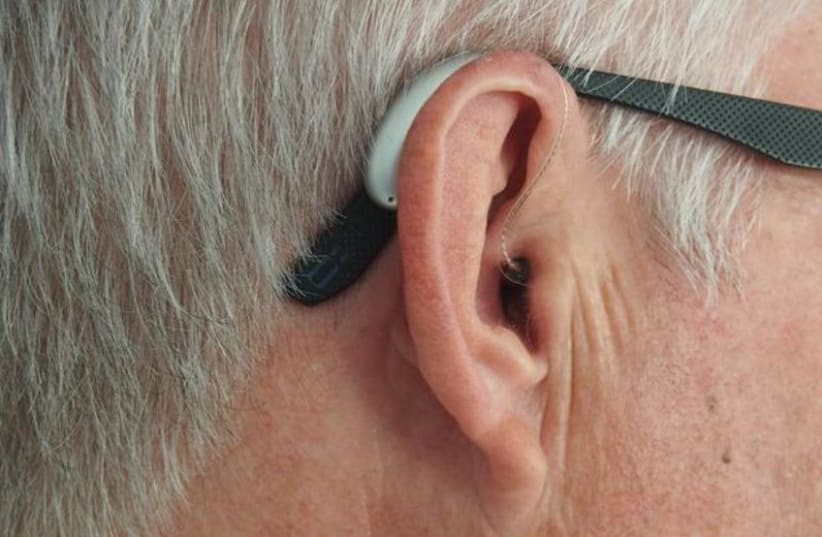  Ear, with hearing aid. (photo credit: MARK PATON, UNSPLASH)