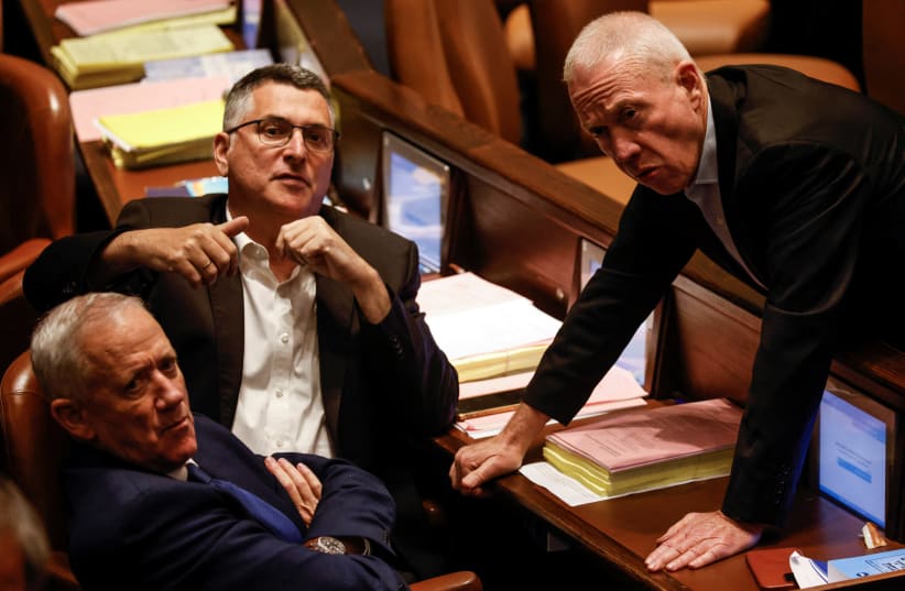  Israeli Defence Minister Yoav Gallant, Benny Gantz, head of National Unity, and opposition lawmaker Gideon Saar look on as lawmakers gather at the Knesset plenum to vote on a bill that would limit some Supreme Court power, in Jerusalem July 24, 2023.  (photo credit: AMIR COHEN/REUTERS)