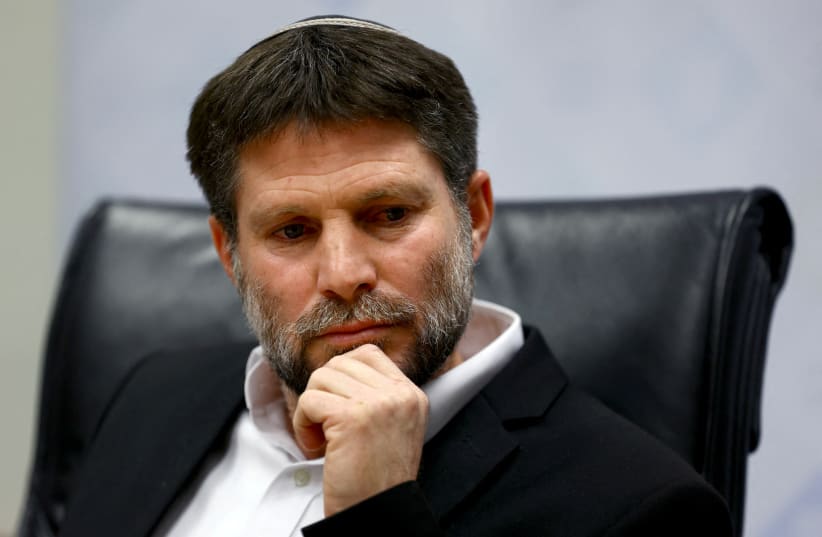   Israeli Finance Minister Bezalel Smotrich attends a news conference after announcing that he will sign an order to seize Palestinian Authority funds and transfer them to the families of victims of Palestinian attacks, at Israel's Finance Ministry in Jerusalem, January 8, 2023.  (photo credit: RONEN ZVULUN/REUTERS)