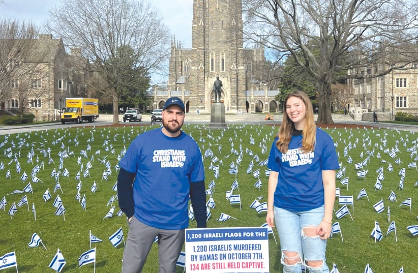  THE WRITER (left) stands at a flag-planting demonstration in which 1,200 Israeli flags were installed on a lawn at Duke University, each flag representing an Israeli murdered on October 7. (photo credit: PASSAGES)