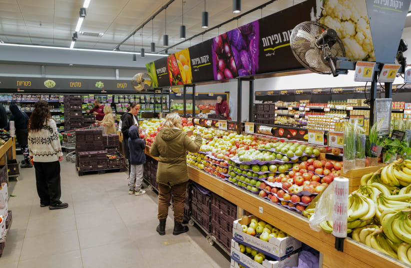  People shop for groceries at the Shufersal Deal supermarket in Katsrin, Golan Heights, on February 9, 2024.  (photo credit: MICHAEL GILADI/FLASH90)