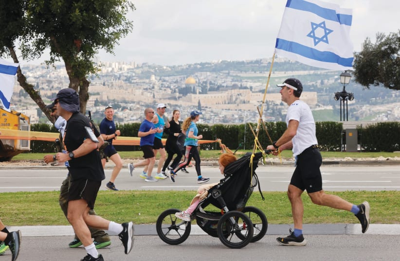  THOUGH RELATIVELY narrow, Jerusalem’s streets miraculously accommodated the staggering 40,000 runners who turned out for the race. (photo credit: MARC ISRAEL SELLEM)