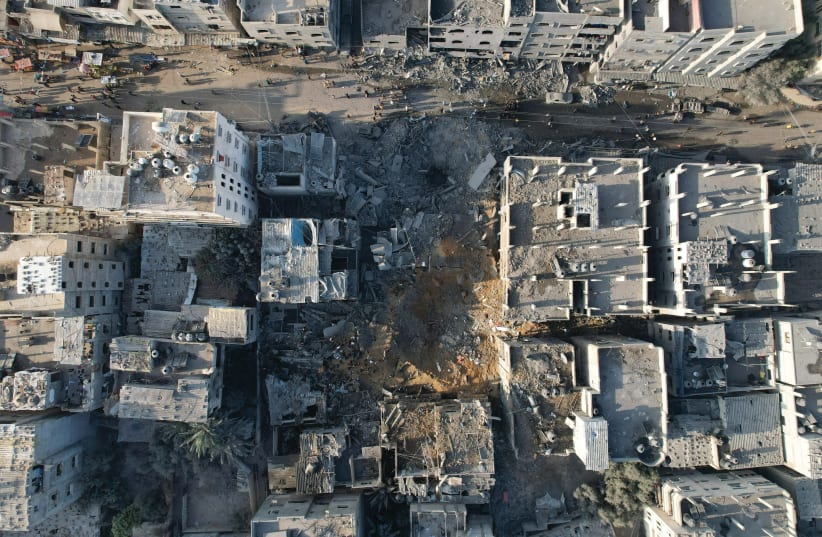  REUTERS RECENTLY pledged they would no longer use new photographs by Mohammed Fayq Abu Mostafa. Yet in a cursory search of the site on Wednesday, over 100 of his old photos quickly came up (such as this one taken Nov. 3, 2023, of Gaza homes damaged by an Israeli airstrike). (photo credit: Mohammed Fayq Abu Mostafa/Reuters)