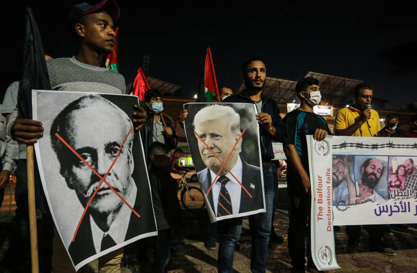  Palestinians hold a posters of US President Donald Trump and Arthur James Balfour during a protest on the anniversary of the Balfour Declaration, in Rafah, in the southern Gaza Strip, on November 4, 2020. (photo credit: ABED RAHIM KHATIB/FLASH90)