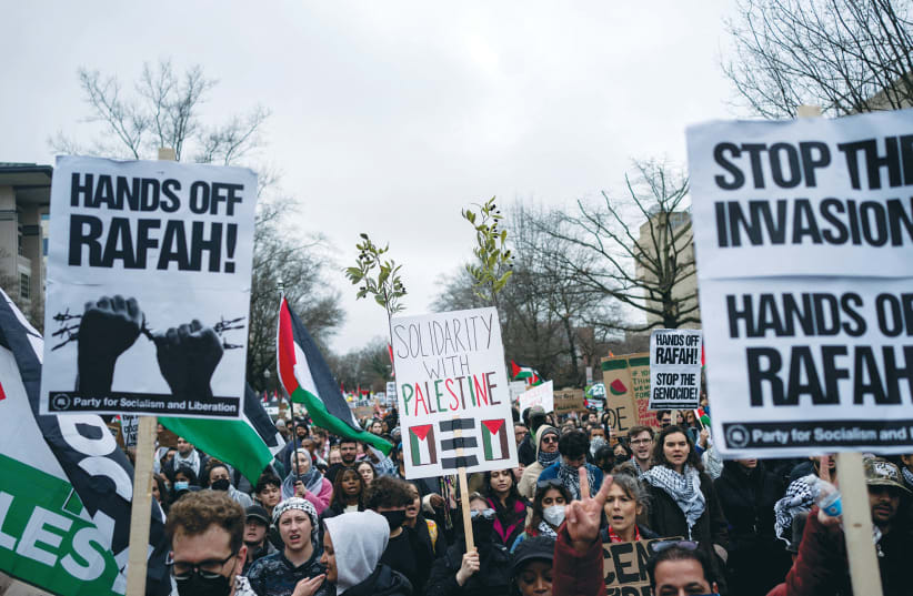  PRO-PALESTINIAN demonstrators march outside the Israel Embassy in Washington, calling for a ceasefire in Gaza, earlier this month. These calls demand that Israel stop attacking Hamas in Gaza but don’t mandate that Hamas stops fighting against Israel, the writer argues.  (photo credit: Bonnie Cash/Reuters)