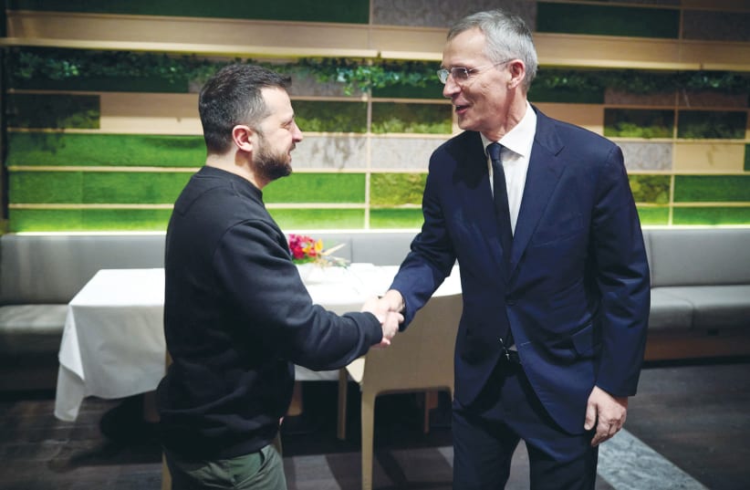 UKRAINE’S PRESIDENT Volodymyr Zelensky and NATO Secretary-General Jens Stoltenberg shake hands before their meeting at the World Economic Forum in Davos, Switzerland, in January. (photo credit: UKRAINIAN PRESIDENTIAL PRESS SERVICE/REUTERS)