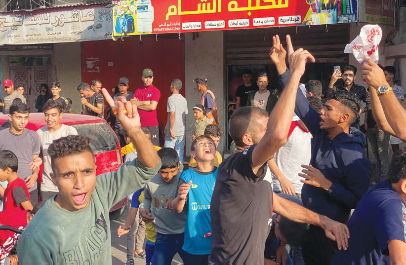  PALESTINIANS CELEBRATE in the Gaza Strip on October 7, after terrorists infiltrated areas of southern Israel and carried out massacres (photo credit: BASSAM MASOUD/REUTERS)