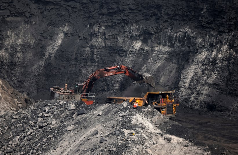  A loader loads coal in the truck at an open cast coal field at Topa coal mine in the Ramgarh district in the eastern Indian state of Jharkhand, India, February 27, 2024. (photo credit: REUTERS/AMIT DAVE)
