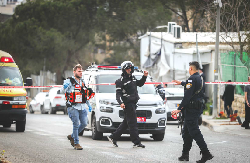 SECURITY AND rescue personnel are at the scene of a stabbing attack in Jerusalem’s Neve Yaakov neighborhood, earlier this month. The attacker was a 14-year-old resident of Jerusalem.  (photo credit: JAMAL AWAD/FLASH90)