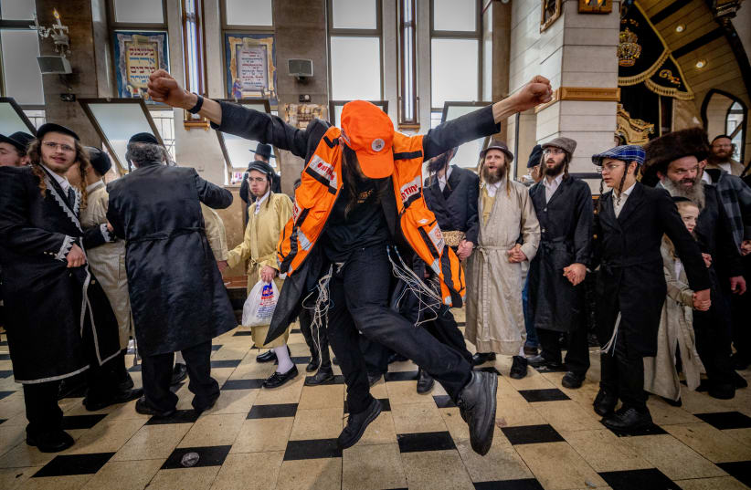  Haredi (ultra-Orthodox) Jewish Israelis are seen dancing in costume amid the holiday of Purim, in Mea She'arim in Jerusalem, on March 8, 2023. (photo credit: YONATAN SINDEL/FLASH90)