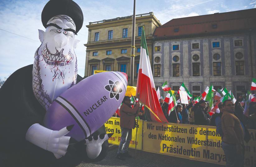  PROTESTING THE Iranian regime with flags and a huge inflated figure representing Supreme Leader Ali Khamenei holding a nuclear bomb, near the Munich Security Conference venue, Feb. 16. (photo credit: Tobias Schwarz/AFP via Getty Images)