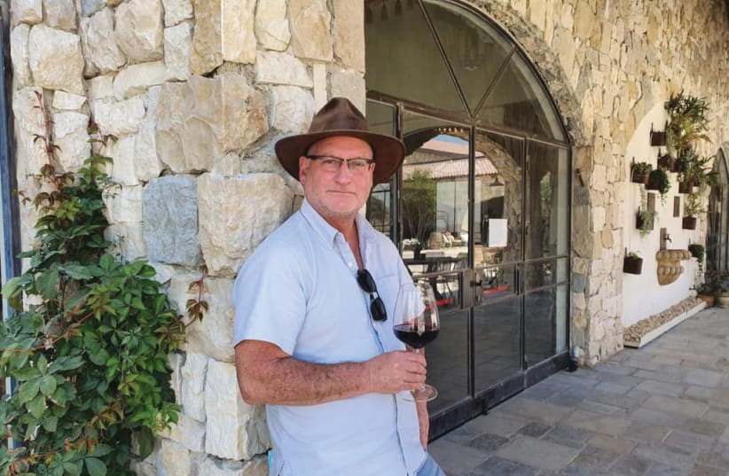  WINEMAKER SAM SOROKA outside Psagot Winery with his ever-present hat, a much-valued purchase from Argentina; and in the vineyard predictably with his dog. He is a great animal lover. (photo credit: Sam Soroka)