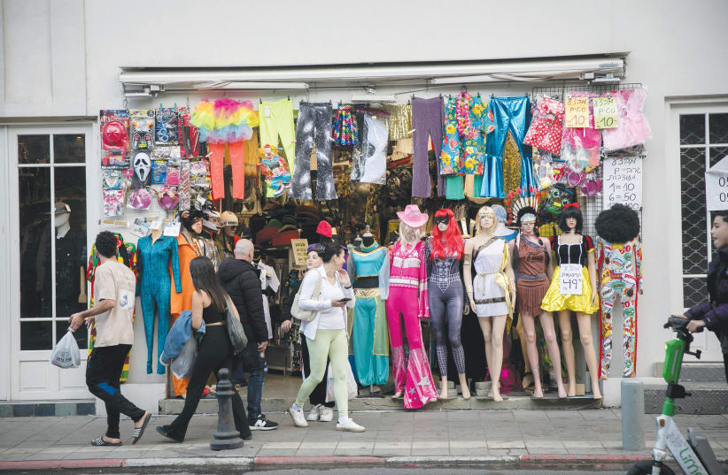  SHOPPERS LOOK for Purim costumes in Tel Aviv on March 18.  (photo credit: MIRIAM ALSTER/FLASH90)