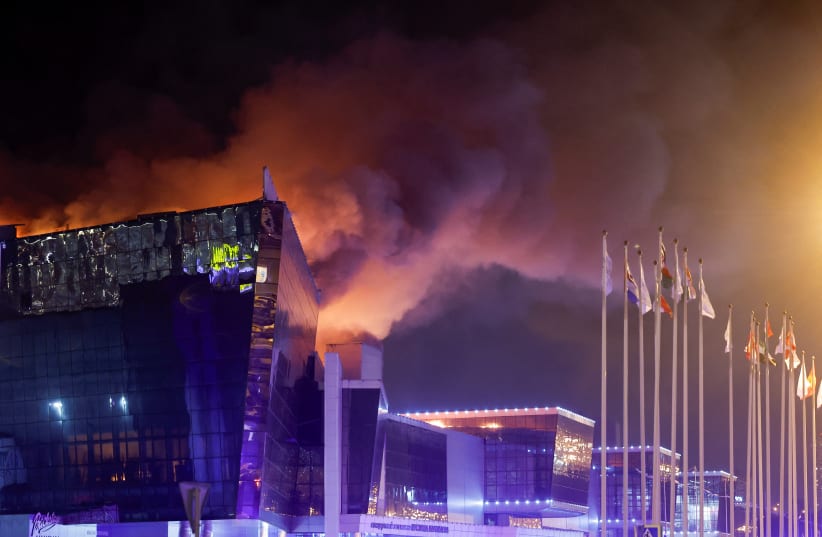 Smoke rises above the burning Crocus City Hall concert venue following a reported shooting incident, outside Moscow, Russia, March 22, 2024. (photo credit: MAXIM SHEMETOV/REUTERS)