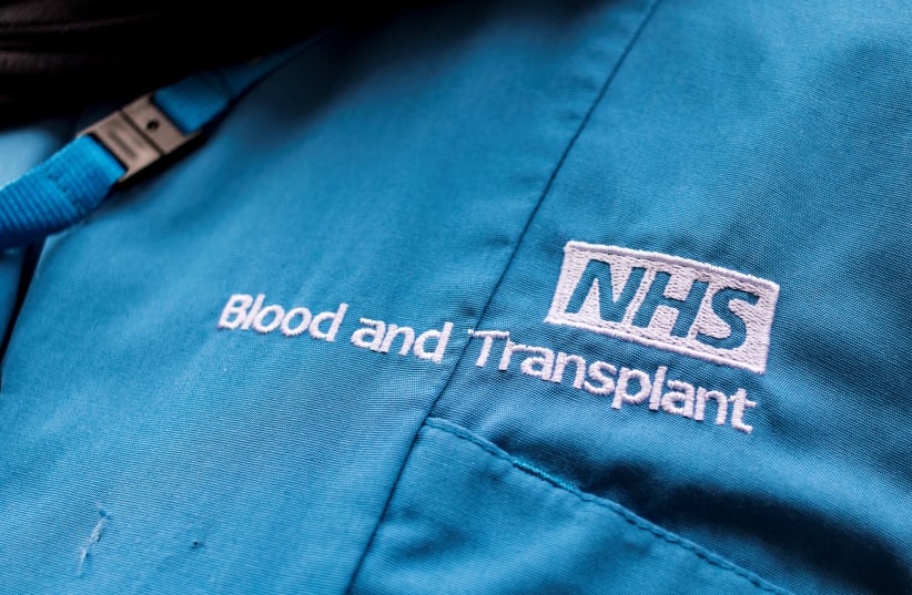 NHS Blood and Transplant embroidery seen on the uniform of a member of staff, following the announcement of the re-balloting voted in the long-running dispute over pay and staffing, in London, Britain, February 18, 2023. (photo credit: MAY JAMES/REUTERS)