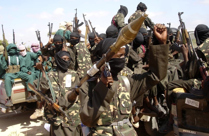 Al Shabaab display their weapons on the outskirts of Mogadishu, December 8, 2008. (photo credit: REUTERS)