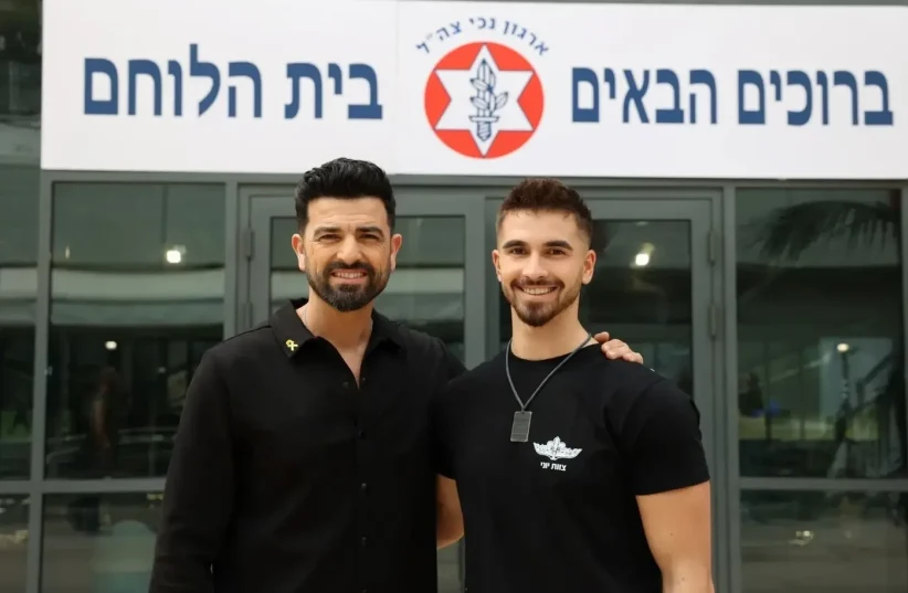   Amos Tamam, the presenter of Bank Hapoalim and the soldier Adam Abramov on the photo set at Beit HaLochem Tel Aviv (photo credit: AVIV GOTTLIEB)