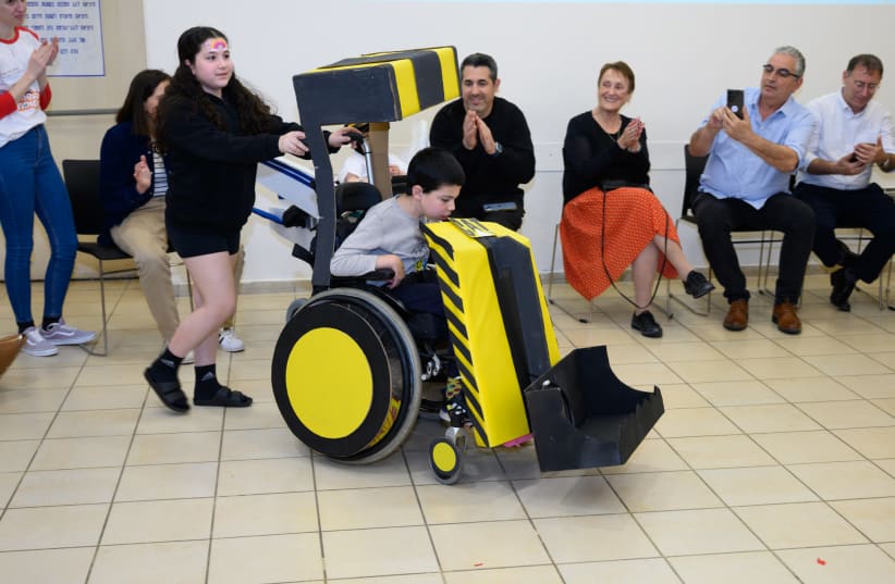  A child with his wheelchair dressed as a bulldozer. (photo credit: Courtesy)