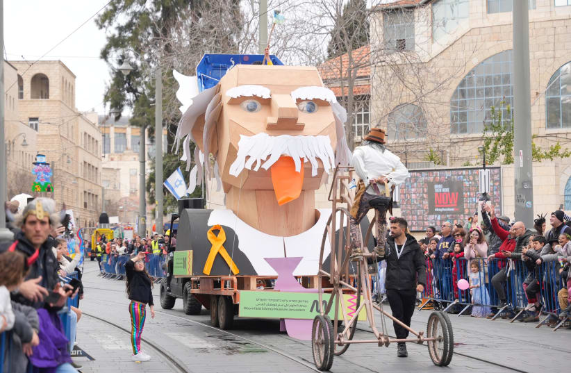  A float of Einstein at the Purim parade in Jerusalem, with a yellow ribbon for the hostages on the front of it. March 25, 2023 (photo credit: JERUSALEM MUNICIPALITY)