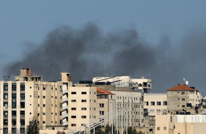  Smoke rises during an Israeli raid at Al Shifa hospital and the area around it, amid the ongoing conflict between Israel and the Palestinian Islamist group Hamas, in Gaza City, March 21, 2024. (photo credit: REUTERS/DAWOUD ABU ALKAS)