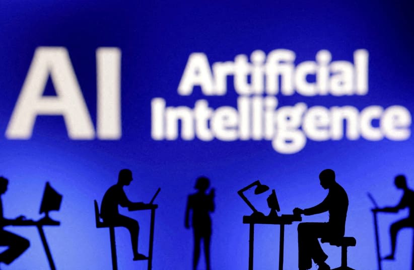  Figuritas con ordenadores y teléfonos inteligentes se ven delante de las palabras "Inteligencia Artificial AI" en esta ilustración tomada, el 19 de febrero de 2024. (photo credit: DADO RUVIC/REUTERS)