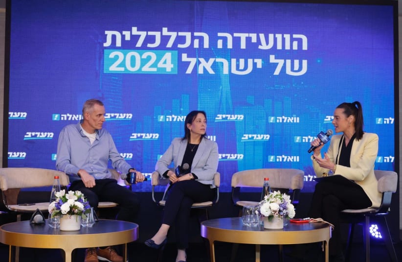  Dafna Landau, (center) Head of the Construction & Real Estate sub-division in Bank Leumi’s Business Division, speaks with Yaakov Quint, Director-General of the Israel Land Authority (left) and journalist Danielle Roth Avneri at the Maariv Economic Conference in Tel Aviv. (photo credit: AVSHALOM SASSONI)