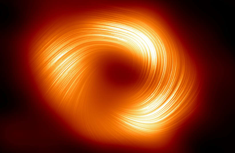  This image shows the polarised view of the Milky Way black hole. The lines overlaid on this image mark the orientation of polarisation, which is related to the magnetic field around the shadow of the black hole. (photo credit: EUROPEAN SOUTHERN OBSERVATORY/HANDOUT VIA REUTERS)