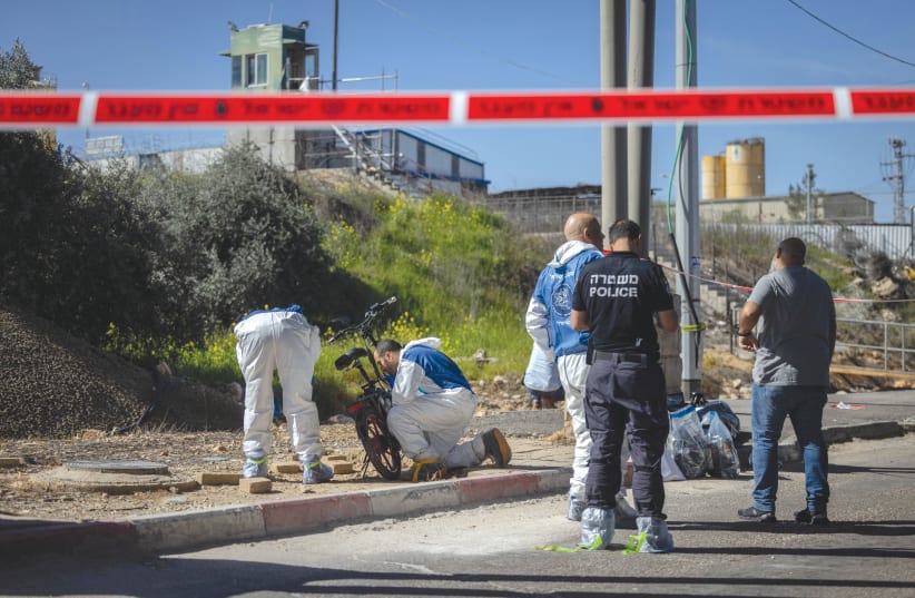  Police and security personnel are at the scene of a stabbing attack near Jerusalem, earlier this month. (photo credit: Chaim Goldberg/Flash90)
