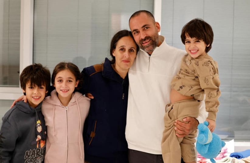 Avihai Brodutch poses with his wife Hagar Brodutch, 40, and their children Oria Brodutch, 4, Yuval Brodutch, 8, and Ofri Brodutch, 10, shortly after Hagar and their children arrived in Israel on November 26 after being held hostage by the Palestinian militant group Hamas in the Gaza Strip, at Schnei (photo credit: SCHNEIDER CHILDREN'S MEDICAL CENTER/HANDOUT VIA REUTERS )