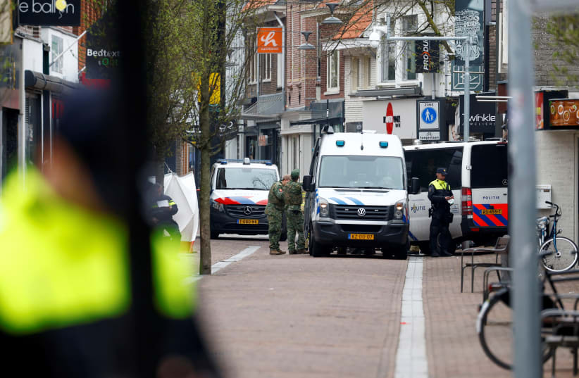Dutch police officers work near the Cafe Petticoat, where several people are being held hostage in Ede, Netherlands March 30, 2024. (photo credit: PIROSCHKA VAN DE WOUW/REUTERS)