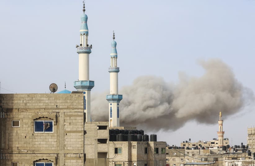  SMOKE RISES following an Israeli strike in Rafah, in the southern Gaza Strip, last week. Prime Minister Benjamin Netanyahu has said there is no way to defeat Hamas without entering Rafah, the writer notes. (photo credit: Ahmed Zakot/Reuters)
