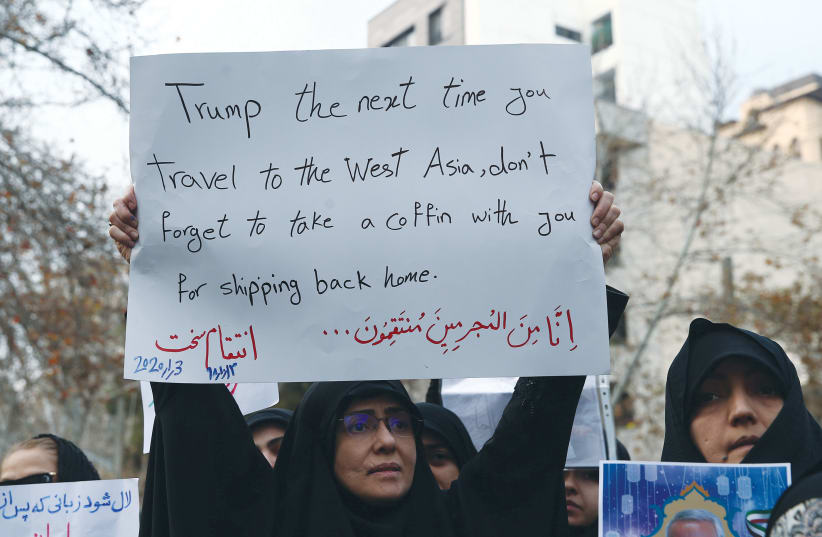  A PROTESTER in Tehran threatens revenge against then-US president Donald Trump for the assassination of Iranian Maj.-Gen. Qassem Soleimani, head of the Quds Force, and Iraqi militia commander Abu Mahdi al-Muhandis, who were killed in an airstrike in Baghdad, 2020.  (photo credit: WEST ASIA NEWS AGENCY/REUTERS)