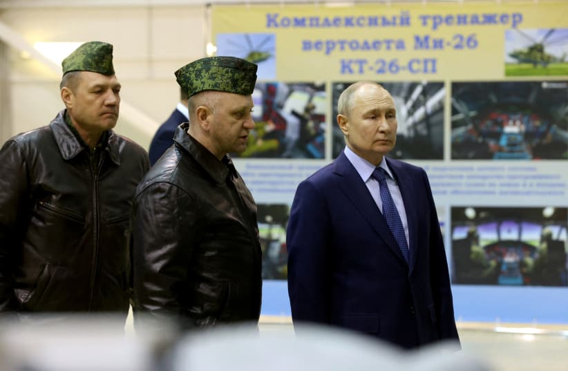  Russian President Vladimir Putin, accompanied by Hero of Russia, head of air combat and tactical training Alexander Karamyshev, visits the 344th State Centre for combat use and retraining of flight crews of the Russian Defense Ministry in the town of Torzhok, Russia March 27, 2024. (photo credit: VIA REUTERS)
