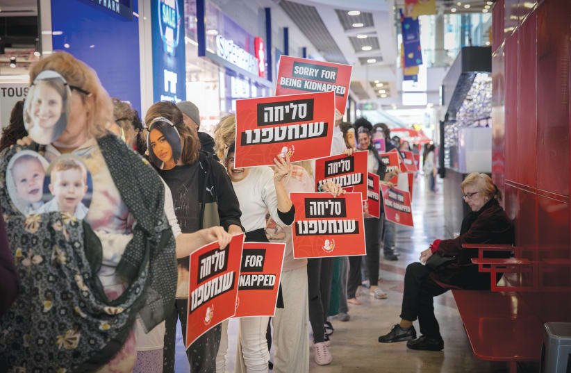  PROTESTERS CALL for the release of hostages held by Hamas in Gaza at a demonstration at Azrieli Mall in Tel Aviv.  (photo credit: MIRIAM ALSTER/FLASH90)