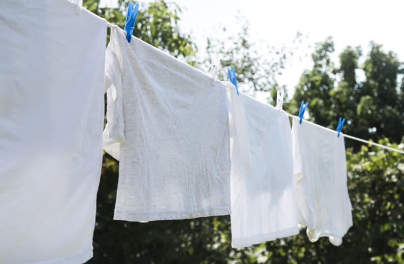  white laundry hanging string outdoors (photo credit: INGIMAGE)