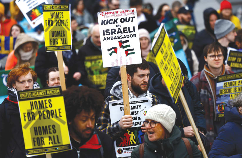  A demonstrator holds a sign calling for the expulsion of Israel's Ambassador to Ireland Dana Erlich, in support of Palestine, at a march against war, hate, and racism, in Dublin, last month. Many people outside of Israel have lost track of why we are fighting this war, the writer argues. (photo credit: CLODAGH KILCOYNE/REUTERS)
