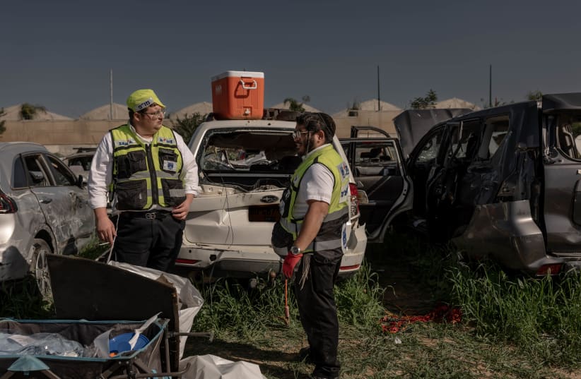  Personal de Zaka trabaja en un campo con coches destruidos de la masacre del 7 de octubre, cerca de la frontera entre Israel y Gaza, 22 de enero de 2024. (photo credit: CHEN SCHIMMEL/FLASH90)