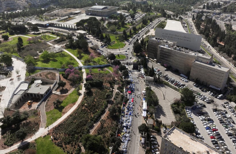  A drone view shows Israeli protesters demanding Israel's Prime Minister Benjamin Netanyahu's ouster, in the wake of the deadly October 7 attack on Israel by the Palestinian Islamist group Hamas and the ensuing war in Gaza, in front of the Knesset, Israeli parliament in Jerusalem, April 1, 2024. (photo credit: REUTERS/ILAN ROSENBERG)