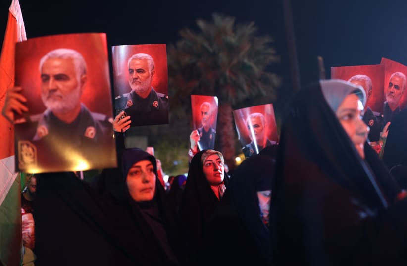  Iranian hold pictures of the late Iranian Major-General Qassem Soleimani, during a gathering in support of Palestinians, in Tehran, Iran, October 7, 2023. (photo credit: Majid Asgaripour/WANA/via Reuters)
