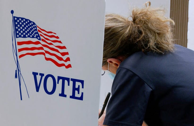  A voter marks a ballot during the primary election and abortion referendum at a Wyandotte County polling station in Kansas City, Kansas, U.S. August 2, 2022.  (photo credit: ERIC COX/REUTERS)
