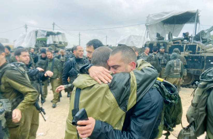  TWO COMMANDERS from the Nahal Brigade embrace at a short closing ceremony just outside of Gaza. (photo credit: AKIVA WEISS)