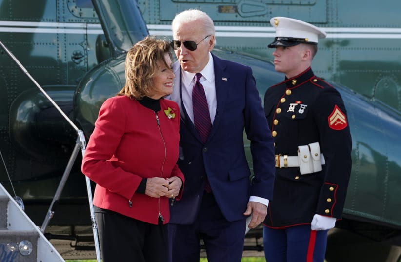  US President Joe Biden speaks to US Representative Nancy Pelosi (D-CA) as he arrives in San Francisco, California, US February 21, 2024. (photo credit: REUTERS/KEVIN LAMARQUE)