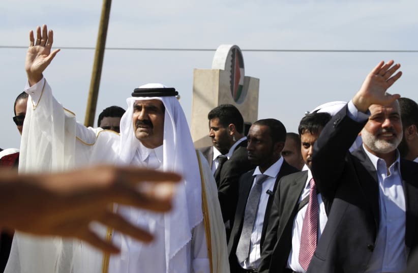  ALREADY IN 2012, Qatar’s then-emir Hamad bin Khalifa Al Thani visited Gaza and donated $400 million to Hamas. Pictured: With Ismail Haniyeh at the cornerstone-laying ceremony of a Qatari-funded rehabilitation center in Gaza City, Oct. 2012. (photo credit: Hatem Moussa-Pool/Getty Images)