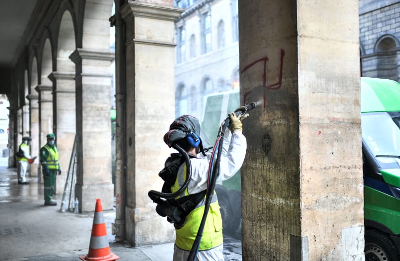  Cleaning swastikas spraypainted in central Paris, 2020.  (photo credit: Stephane De Sakutin/AFP via Getty Images)