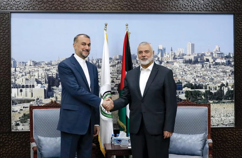  Iran’s Foreign Minister Hossein Amir Abdollahian meets Hamas leader Ismail Haniyeh in Doha, Qatar, on February 13, 2024. In the background is a large photograph of Jerusalem. (photo credit: WANA/REUTERS)