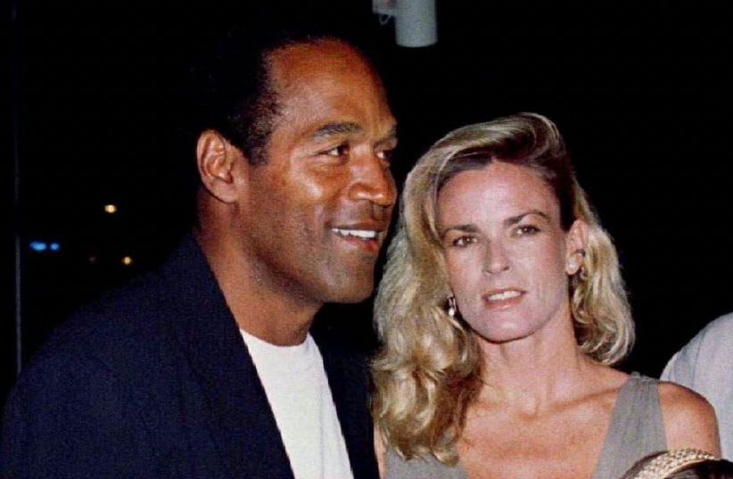  O.J. Simpson is shown with his ex-wife Nicole Simpson and their children, daughter Sidney Brooke, 9, and son Justin, 6, at the March 16, 1994, premiere of Simpson's film "Naked Gun 33 1/3: The Final Insult, " in Los Angeles. (photo credit: REUTERS)