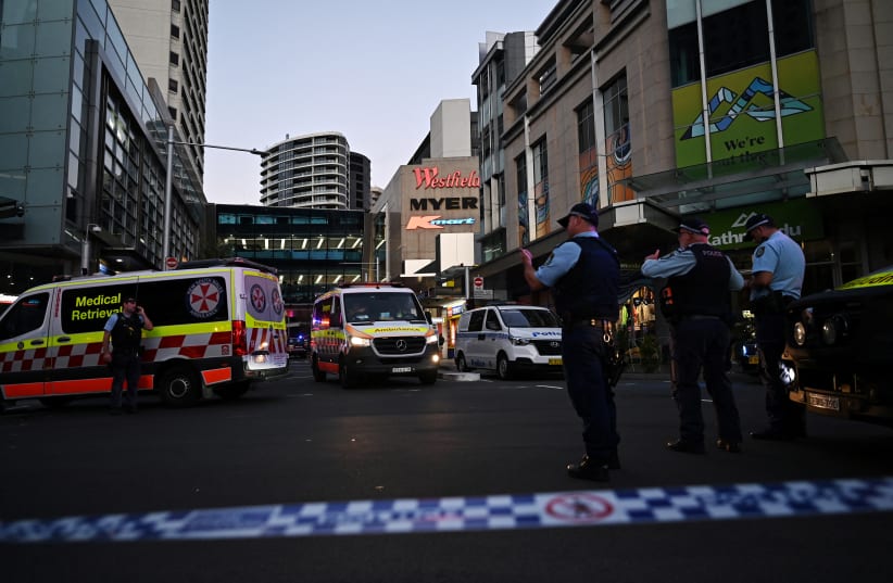  Emergency service workers stand near Bondi Junction after multiple people were stabbed inside the Westfield Bondi Junction shopping centre in Sydney, April 13, 2024. (photo credit: AAP Image/Steven Saphore via REUTERS)